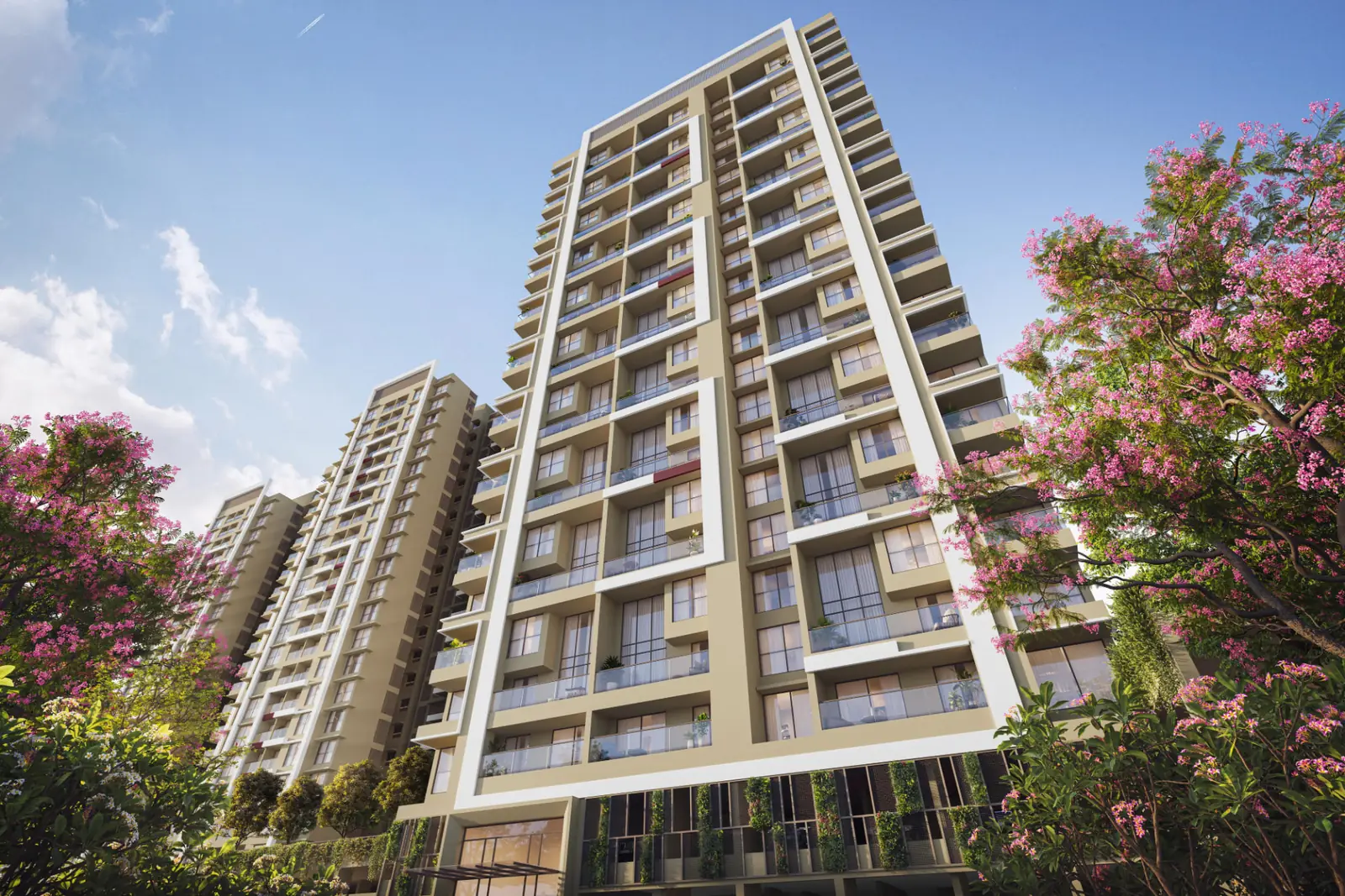 Vyomora high-rise tower seen from ground level amid flowering trees